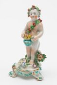 A Bow porcelain putti allegorical of Winter: modelled naked except for a holly wreath and garland