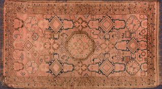 A Belouchistan rug:, the shaded rose field with a central octagonal medallion,