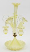 A vaseline glass epergne: with central fluted trumpet shaped vase with frill rim and applied tooled