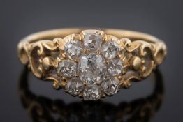 An antique gold and diamond mounted circular cluster ring: with round old brilliant-cut diamonds