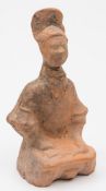 A Chinese pottery seated figure: wearing ornate headdress and jacket, Han Dynasty,