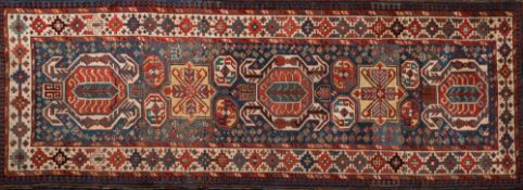 A Lenkoran runner:, the indigo and pastel blue field with geometric medallions and all over designs,