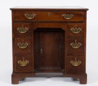 A George III mahogany kneehole desk:, the rectangular top with a moulded edge,