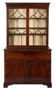 An early 19th Century mahogany secretaire bookcase:, the upper part with a moulded cornice,