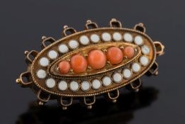 A Victorian gold, graduated coral and white enamel oval brooch: approximately 2.3cm long x 1.