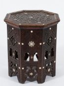 A Near Eastern carved wood and mother of pearl inlaid octagonal table:,