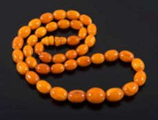 A graduated amber coloured bead, single-string necklace: with 41 oblong beads graduated from 11.