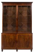 An early 19th Century mahogany library bookcase:, the upper part with a moulded cornice,