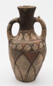 A Neolithic-style painted pottery two-handled vase: decorated in black and iron red with a hatched