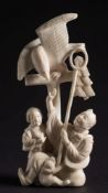 A Japanese carved ivory okimono: depicting peasants and monkey being attacked by an eagle, signed,