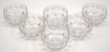 A set of six cut and engraved glass finger bowls: engraved and cut with a band of fruiting vines,