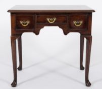 A mid 18th Century red walnut rectangular lowboy:, the top with rounded corners and a moulded edge,