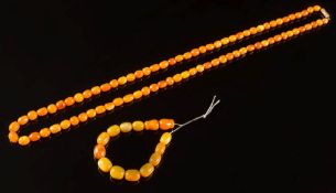An amber coloured bead, single-string necklace: with beads graduated from 9mm long to 12mm long,