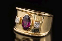 A ruby and diamond three-stone ring: with central oval ruby approximately 7.