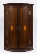 A late 18th/early 19th Century oak and mahogany and inlaid bow fronted hanging corner cupboard:,