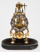 A late twentieth century brass skeleton clock: the eight-day duration single fusee movement with an