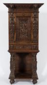 A 19th Century carved oak upright cabinet on a stand:, with applied earlier pieces of woodwork,