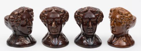 A set of four Rockingham pottery window rests: each modelled head and shoulders as George