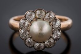 A gold, pearl and diamond circular cluster ring: with central button pearl 6.