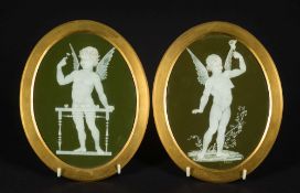 A pair of Wedgwood pate sur pate oval plaques by Frederick Rhead: decorated in white on a green