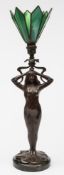An Art Nouveau influence bronzed metal table lamp: the semi naked female partially draped and