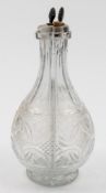 An unusual 19th century cut glass four division liqueur decanter: of baluster form with hobnail and