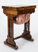 A Victorian rosewood games and work table:, with a rectangular velvet lined hinged top,