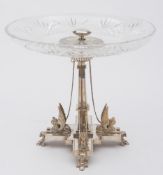 A late 19th century Elkington-style plated tazza: the clear cut glass circular dish with palmette