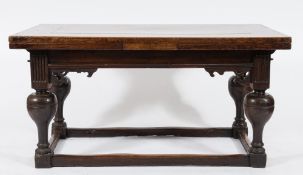 A 17th Century Dutch oak draw leaf dining table:, with a rectangular top on bulbous turned legs,