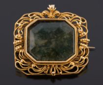 A late 19th century gold and moss agate rectangular brooch: the central moss agate panel within a