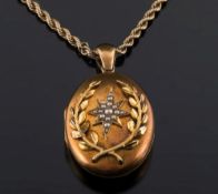 A late 19th century gold oval locket: with central seed-pearl star within a gold wreath and