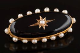 A Victorian gold, black onyx and seed-pearl oval mourning brooch:,