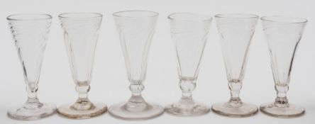 Six English dwarf ale glasses: of wrythen moulded form on rudimentary stem and conical foot,