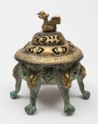 A Chinese gilt-copper incense burner and cover: the pierced cover with bird finial and engraved
