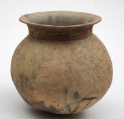 A large Chinese pottery jar: of globular form with flared rim and red painted neck,