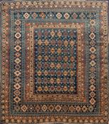 An Erivan rug:, the indigo rectangular panel field with hooked geometric medallions,