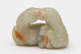 A Chinese jade carving of two reclining horses: with heads touching,