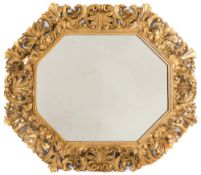 A 19th Century carved giltwood Florentine octagonal wall mirror:, the plate within an acanthus,