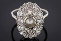 A pearl and diamond oval cluster ring: with central split pearl (untested) approximately 5.