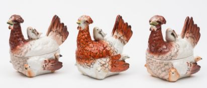 A set of three Staffordshire hen and chick tureens and covers: with rust/brown plumage,