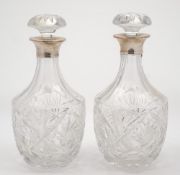 A pair of Elizabeth II silver mounted clear glass decanters and stoppers, maker Roberts & Dore Ltd,