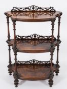 A Victorian walnut serpentine fronted three tier whatnot:,
