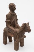 A Dogon (Mali) terracotta equestrian figure: the rider wearing armlets and a vessel suspended over