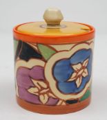 A Clarice Cliff pottery preserve pot and cover in the Gardenia pattern: of cylindrical form and