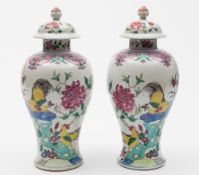 A pair of Chinese famille rose baluster vases and covers: painted with cockerels,