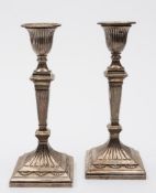 A pair of Victorian silver candlesticks.