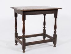 An 18th Century oak rectangular side table:, the top with a moulded edge, on turned baluster legs,