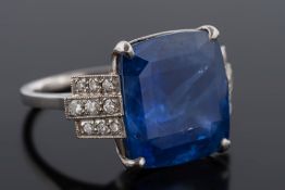 A platinum, sapphire and diamond ring: with central cushion shaped sapphire, 14.7mm x 13.5mm x 8.