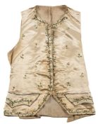 A Regency period cream silk waistcoat: the ivory ground with floral meander edging to the collar,