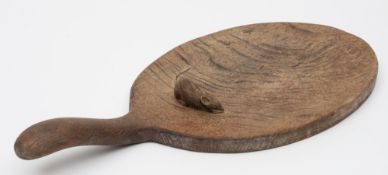 By Robert Thompson of Kilburn 'The Mouseman' an oak cheese platter: of oval outline with swept
